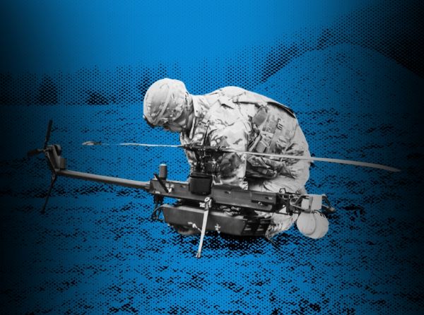 Soldier kneeling by a drone