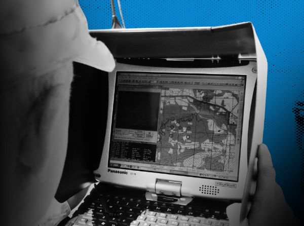 Person looking at a small computer with a map on the screen